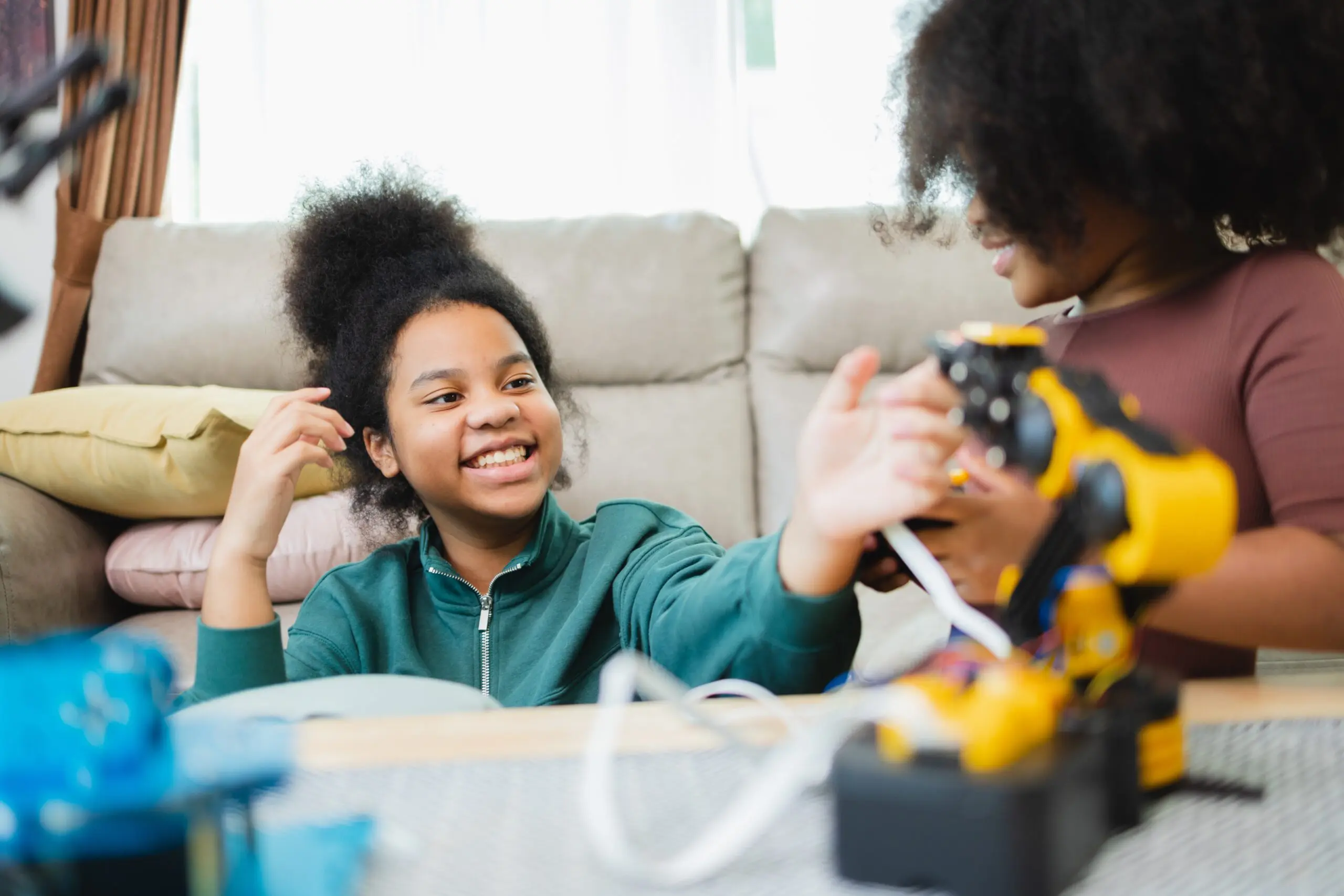 Teen student building a robot with adult supervision