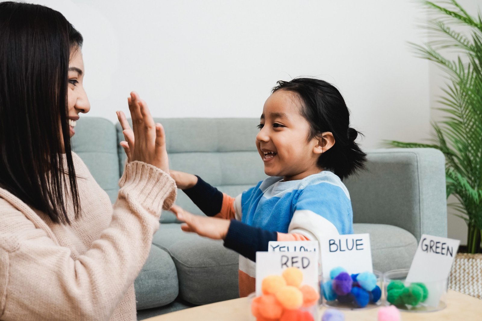 Asian kid playing didactic game with his mom at home - Montessori education concept - Focus on mother face Asian kid playing didactic game with his mom at home Montessori education concept Focus on mother face