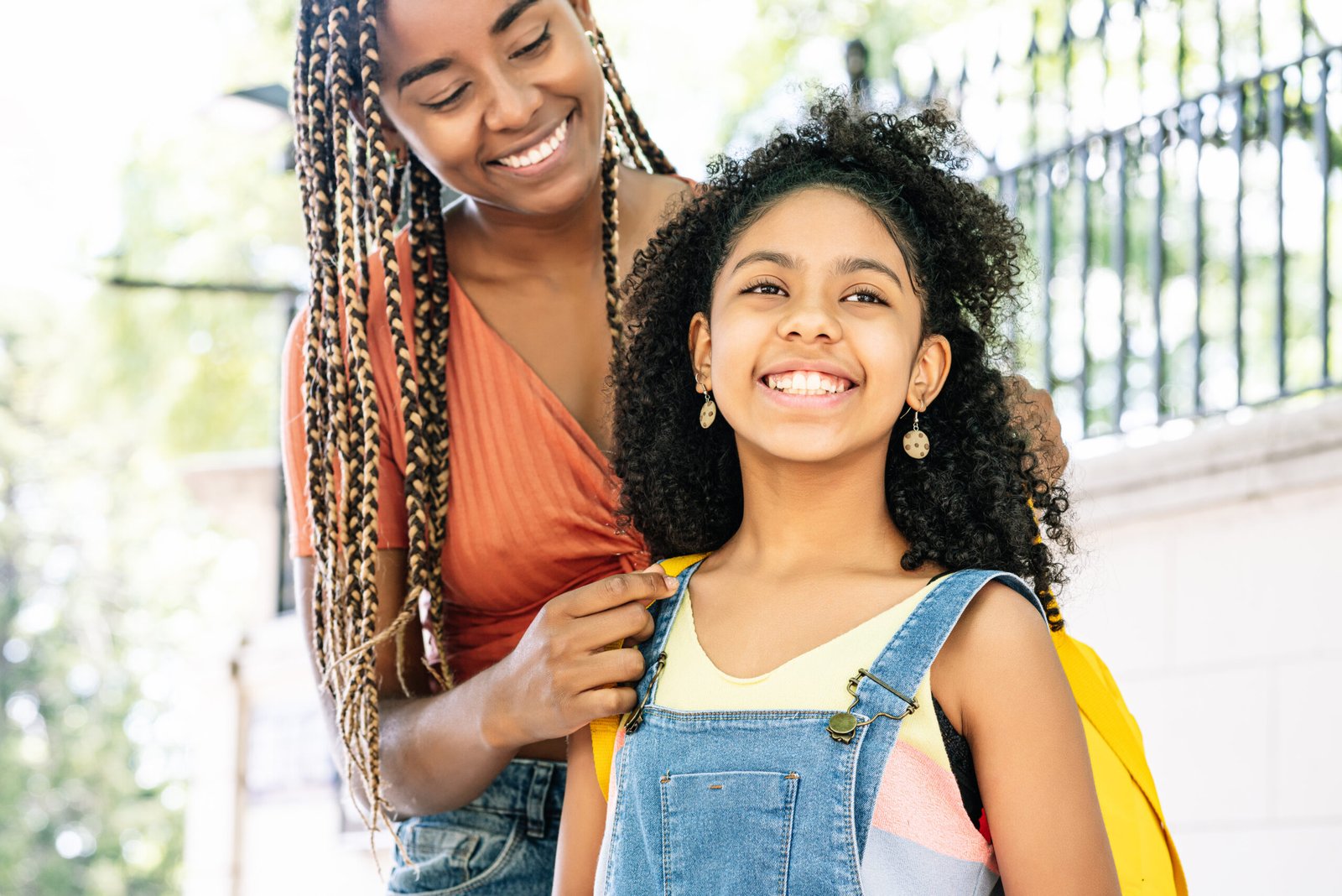 Mother taking her daughter to the school.